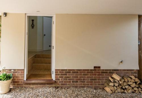 a room with a brick wall and a doorway at The Cartlodge in Wickham Bishops
