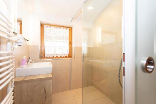 a bathroom with a sink and a shower at Appartement Schöne Aussicht in Saalbach Hinterglemm