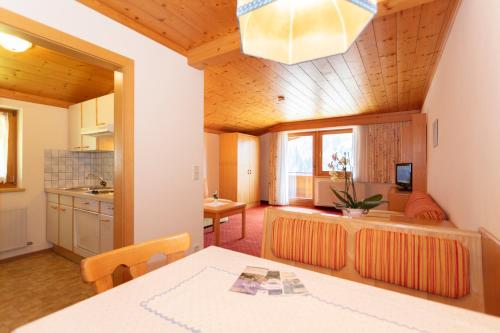 a kitchen and living room with a table and a dining room at Appartement Schöne Aussicht in Saalbach Hinterglemm