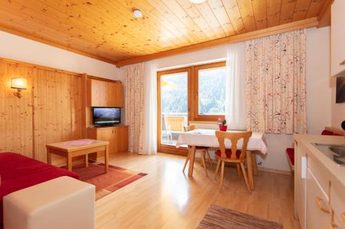 a living room with a table and a dining room at Appartement Schöne Aussicht in Saalbach Hinterglemm
