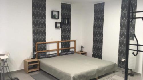 a bedroom with a bed in a room at Cuki Apartmanok in Dombóvár