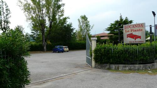 a sign for a hotel in a parking lot at Albergo Le Piante in Manerba del Garda