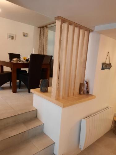 a staircase in a living room with a piano at Granville plage normandie mont saint Michel in Granville