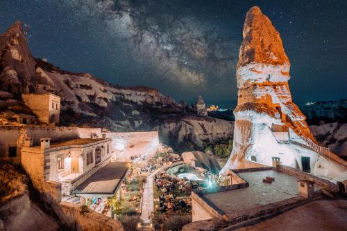 a view of a city at night at Aza Cave Cappadocia Adult Hotel in Göreme