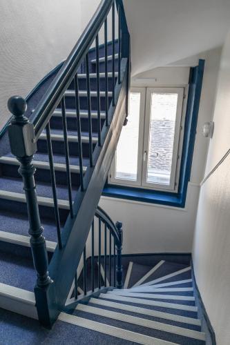 a blue and white staircase with a window at Atlantic Hotel Rennes Centre Gare in Rennes