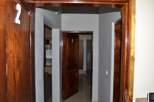 a hallway with a wooden door and a mirror at Ponta View Hotel in Ponta do Ouro