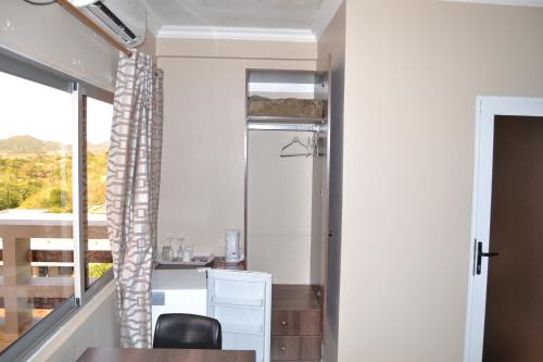 a room with a desk and a window at Ponta View Hotel in Ponta do Ouro