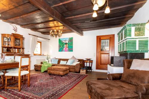 a living room with a couch and a table at Historic Lakeview Apartments Hallstatt in Hallstatt