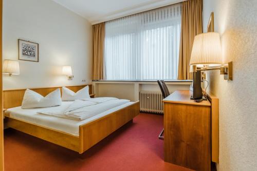 Postel nebo postele na pokoji v ubytování Hotel am Marschiertor