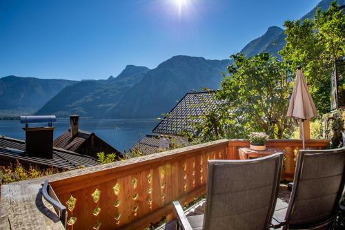 a balcony with a view of a lake and mountains at Historic Lakeview Apartments Hallstatt in Hallstatt