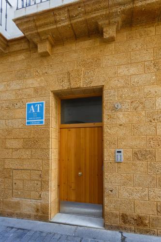 a building with a door with a sign on it at Apartamentos La BRUJULA by CadizRentals in Cádiz