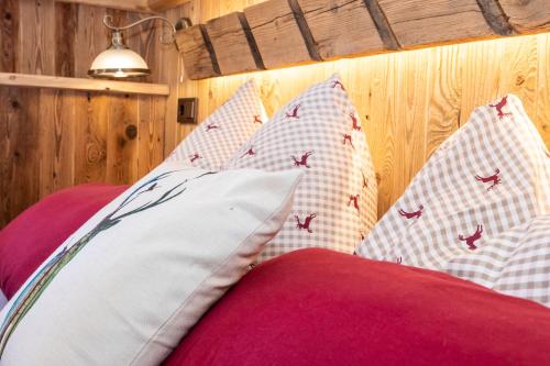 a bedroom with red and white pillows on a bed at Historic Lakeview Apartments Hallstatt in Hallstatt