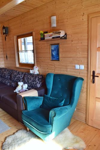 a living room with a couch and a chair at Leśny Zakątek Uroczysko in Rychtal