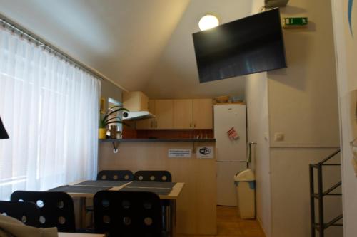 a kitchen with a table and chairs and a refrigerator at Penzion Hustopeče in Hustopeče