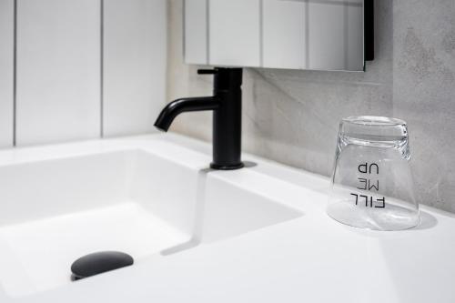 a glass jar with the word on it sitting on a kitchen counter at Gooiland Hotel in Hilversum