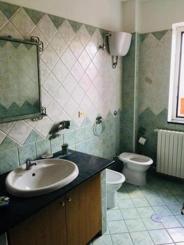 a bathroom with a sink and a toilet at La Vecchia Lanterna da Ines...... in Romagnano al Monte