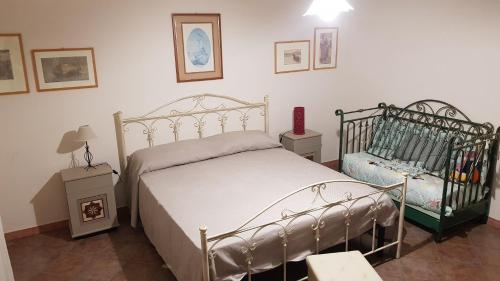 a bedroom with a bed and two night stands at La Vecchia Lanterna da Ines...... in Romagnano al Monte