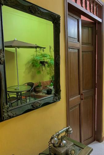 a mirror above a sink with a table in a room at Casa Grande in Medellín