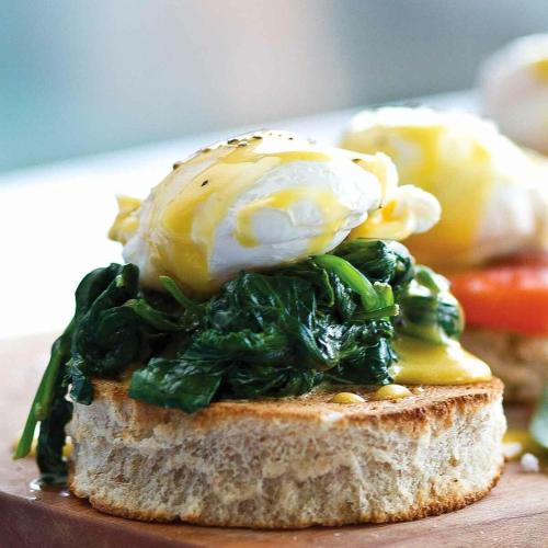 an egg on top of a piece of bread with spinach at The Seyyida Hotel and Spa in Zanzibar City