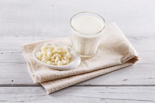a bowl of cereal and a glass of milk on a napkin at The Seyyida Hotel and Spa in Zanzibar City