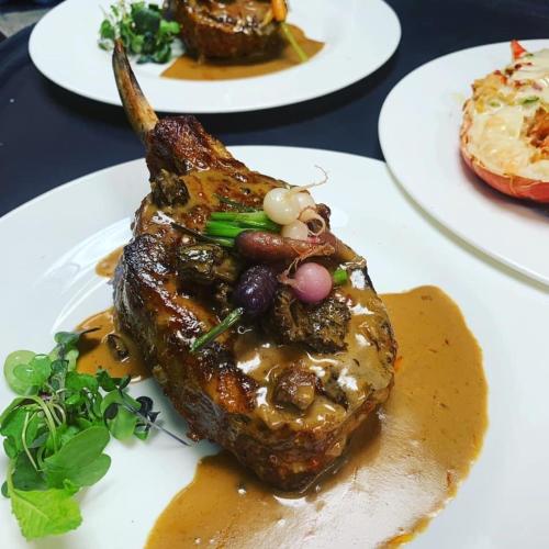 a piece of meat on a white plate with sauce at The Seyyida Hotel and Spa in Zanzibar City