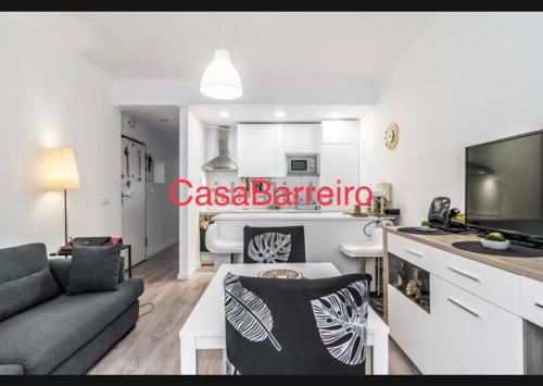 a living room with a couch and a kitchen at CasaBarreiro in Barreiro