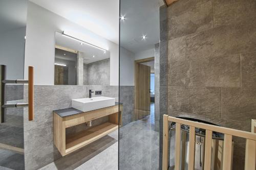 a bathroom with a sink and a mirror at Appartements Gappmaier in Saalbach Hinterglemm