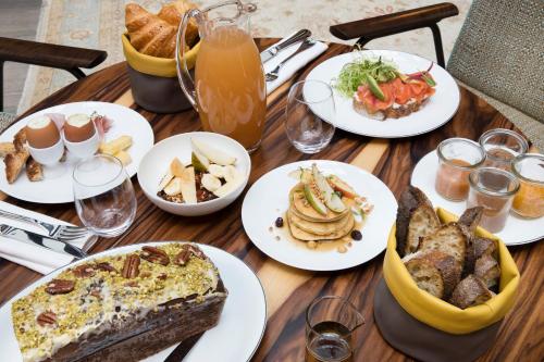 a wooden table with plates of food on it at Maison Bréguet in Paris