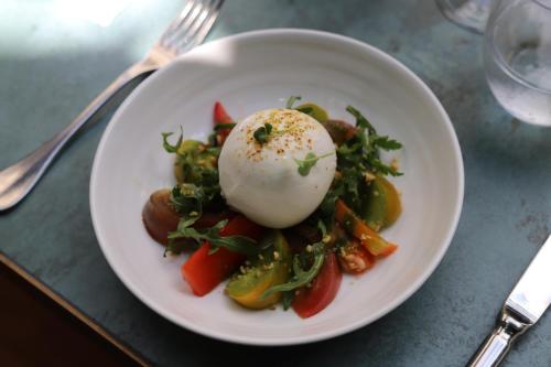 a plate of food with an egg on top of vegetables at Maison Bréguet in Paris