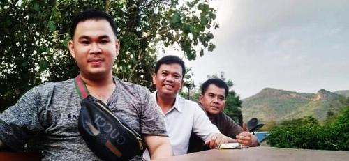 a group of three men sitting at a table at บ้านเดอะเมาเท่น By The Mountain Ozoneบ้านโอโซนขุนเขาแก่งกระจาน in Ban Song Phi Nong