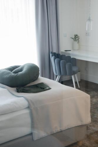 a bed with two pillows on it in a room at Mały Sopot Boutique in Iława