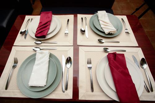 a table with plates and cutlery on a table at The Congress Hotel in Accra