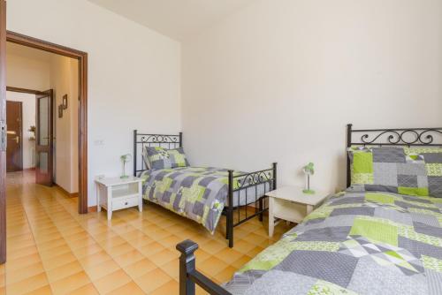 a bedroom with two beds and a hallway at Casa al vecchio mulino in Negrar