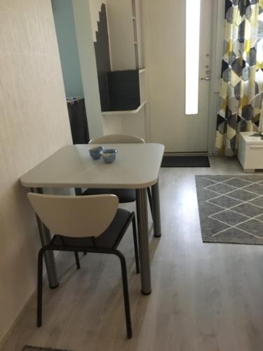 a dining room table with two chairs and a table at MajoitusMattila in Ylivieska