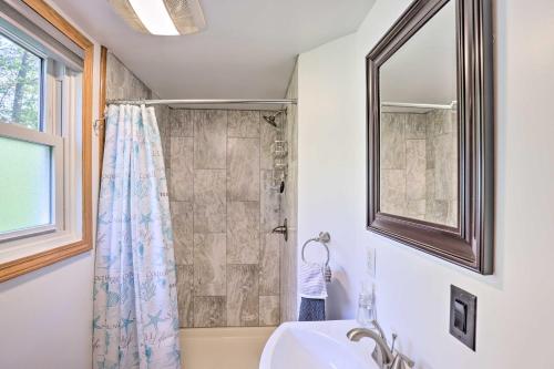 a bathroom with a shower and a sink and a mirror at Aunt Als Place with Private Deck and Fire Pit! in Rushville