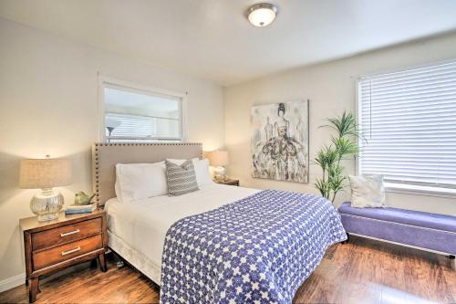 a bedroom with a bed and a blue couch at Chula Vista Retreat about 1 Mi to Third Avenue Village in Chula Vista