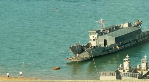a boat is docked at a dock in the water at GOD’S Queen Esther in Nangan