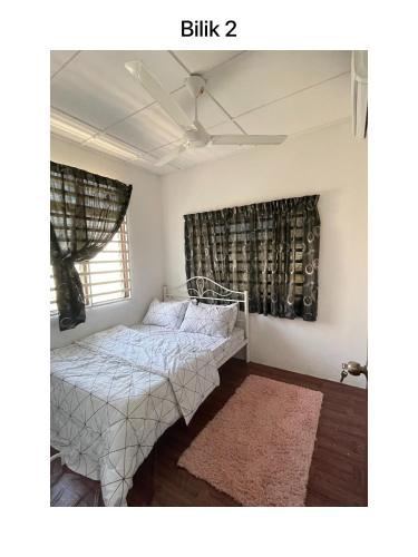 a bedroom with a bed and a window at Wafiy No.47 in Kuantan
