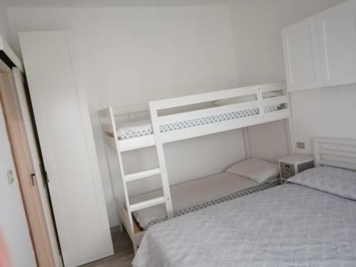 a bedroom with two bunk beds and a ladder at VACANZA A MIRAMARE in Rimini