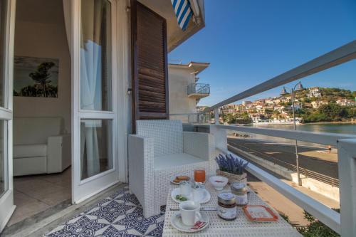 a breakfast table on a balcony with a view of the ocean at 100 passi dal mare in Agropoli