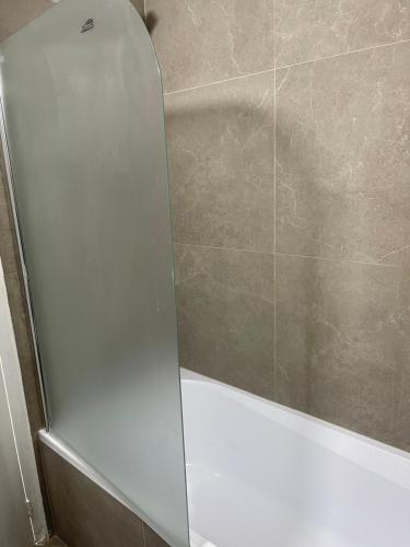 a shower with a glass door in a bathroom at Alex Beach Apartment 34 in Larnaca