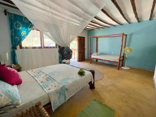 a bedroom with two beds in a room at Oleza Boutique Hotel Zanzibar in Michamvi