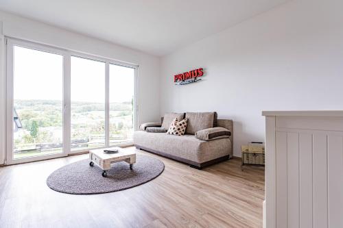 a living room with a couch and a table at Architektenwohnungen mit Panoramablick bei Köln in Lindlar