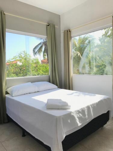 ein Schlafzimmer mit einem großen Bett und einem Fenster in der Unterkunft Casa de pescador in Flecheiras