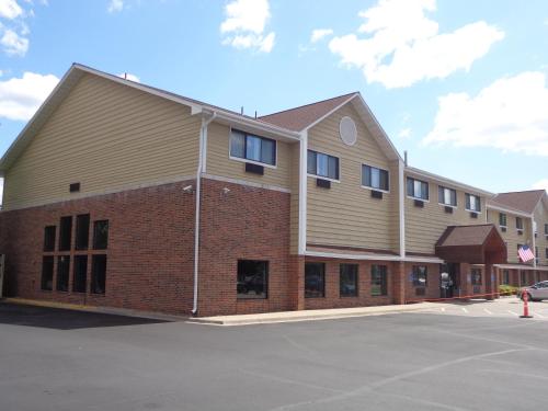 a large brick building with windows in a parking lot at Baymont by Wyndham Bloomington MSP Airport in Richfield