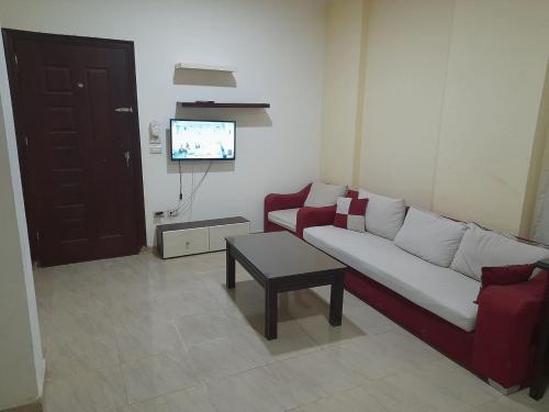 a living room with a couch and a table at Hurghada Comfort Apartments in Hurghada