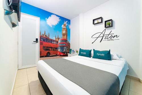 a bedroom with a bed with a mural of a bus at Ayenda Aston in Cúcuta