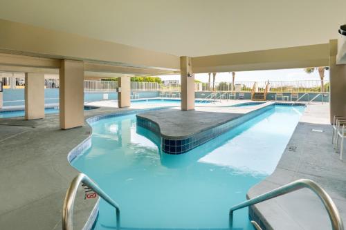 a swimming pool with blue water in a building at Palette Resort Myrtle Beach in Myrtle Beach