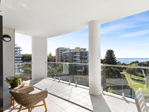 an apartment balcony with a view of the ocean at Cove 603 in Forster