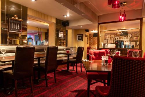 a restaurant with tables and chairs and a bar at Miller & Carter Brighton by Innkeeper's Collection in Brighton & Hove